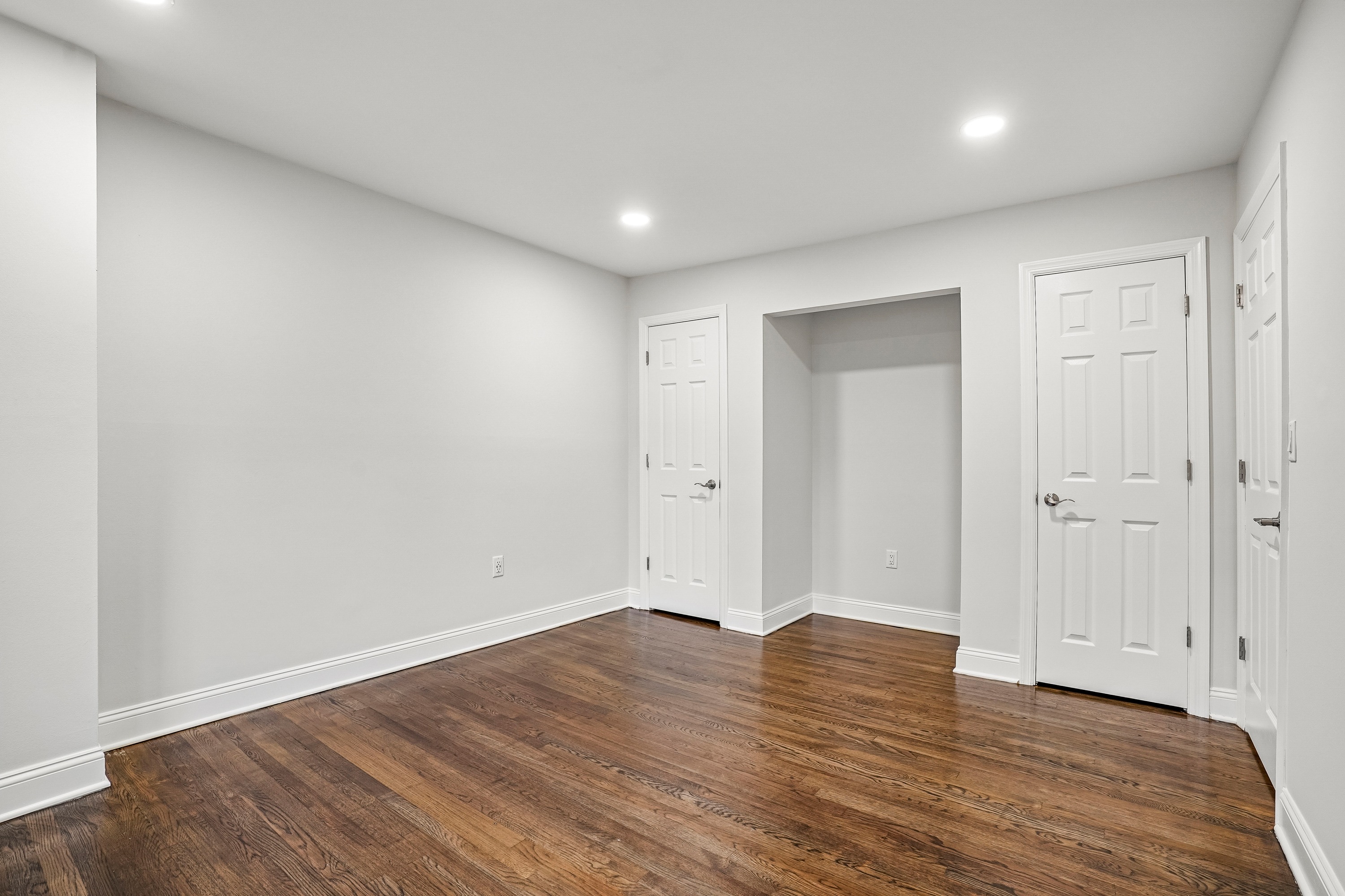 A room with wooden floors and white walls.